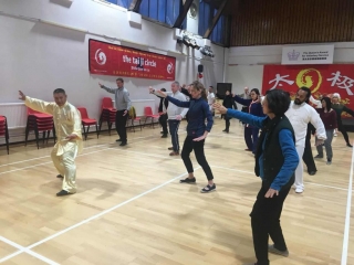 The whole group joins in to follow Shifu Liu SHifu Liu teaching Chen Taijiquan at the Fundraiser